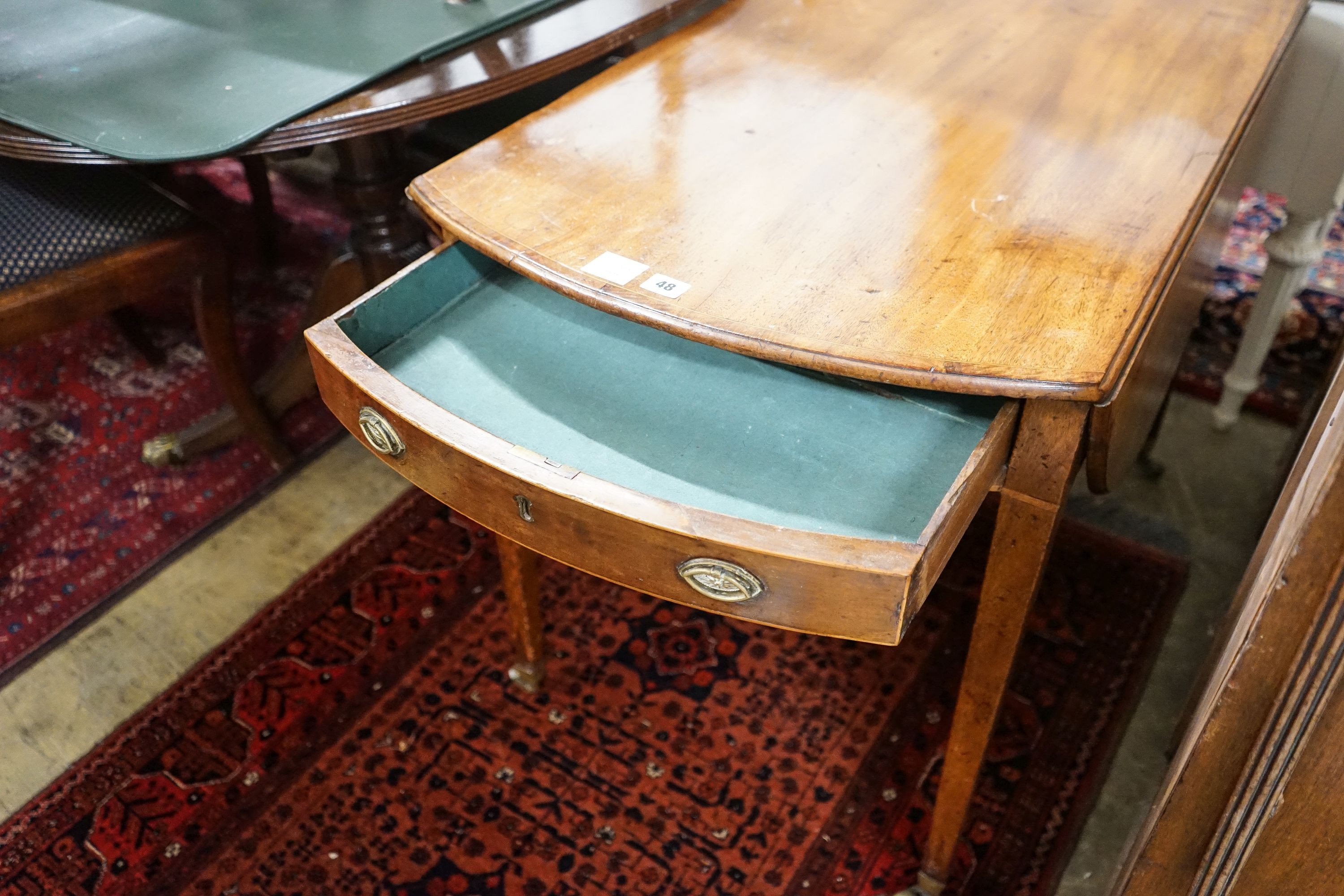 A George III banded mahogany oval topped Pembroke table, width 59cm, depth 102cm, height 71cm